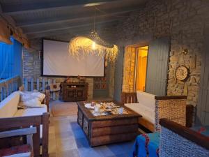 a living room with a large projection screen at Demeure de charme OLIVIRA in Vesseaux