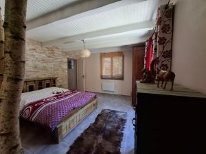 a bedroom with a bed and a brick wall at Demeure de charme OLIVIRA in Vesseaux +89 photos