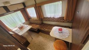 an overhead view of a living room with a couch and a table at CHEZ JOSETTE caravane Camping le sorbier Montignac Lascaux in Montignac