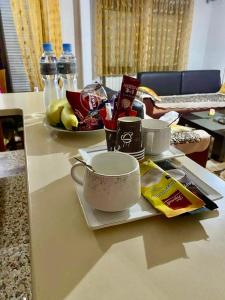 a table with a cup and a plate of food at City Square Apartment 1st floor in Strumica
