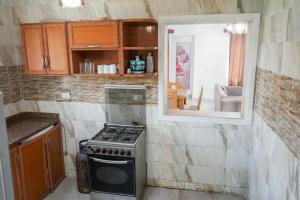a kitchen with a stove and a window at Marseilia Beach 4 - Families Only in El Alamein