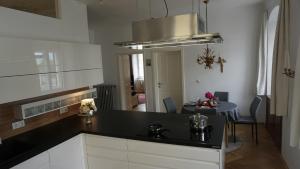 a kitchen with a black counter top and a table at Comfort Apartment am Schergentor in Hall in Tirol +1 photo
