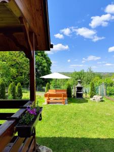 a picnic table and an umbrella in a yard at Bajkowa dolina in Niegowa +8 photos