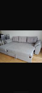 a large white couch sitting in a room at J&M Apartman Zlatibor in Zlatibor
