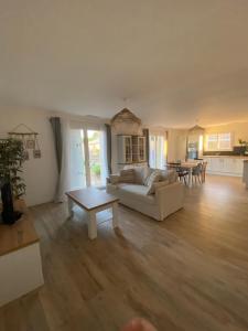a living room with a couch and a table at Villa on Arcachon Bay in Audenge