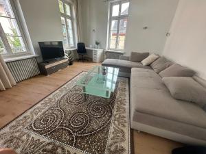 a living room with a couch and a coffee table at Große Ferienwohnung Limburg Diez in Diez