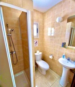a bathroom with a toilet and a sink and a shower at Chrystal Rocks Apartment in Ayia Napa