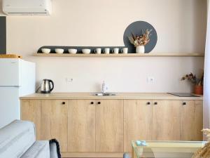 a kitchen with a counter with a sink and a refrigerator at Elegant Apartment - Beachside Riviera NEW in Durrës +236 photos