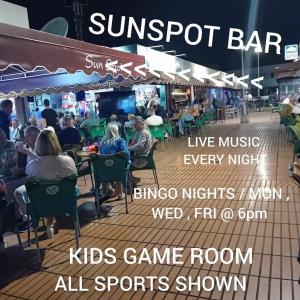 a group of people sitting in chairs at a restaurant at Montecarlo 35 or 45 first row with air conditioning & WI-FI & sound insulation in Puerto Rico de Gran Canaria