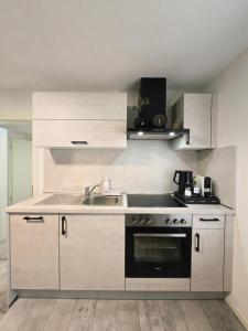 a kitchen with a sink and a stove at Merci's - Legoland - Garden - Parking - Klima AC in Günzburg