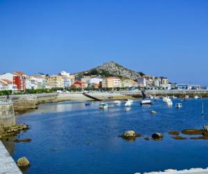 a view of a harbor with boats in the water at O AREAL DE NATALIA in Muxia