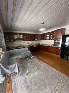 a kitchen with a table in the middle of a room at La villa de Ramil in Baku