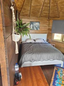 a bedroom with a bed in a cabin at The Vie Llage - Authorial Suites Bungalows in Vagos
