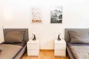 a bedroom with two beds and two night stands at CosyHomes24 - Centrally with balcony and parking space - Ge09b in Gelsenkirchen
