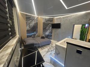 a bedroom with a bed and a sink and a mirror at Wellness Suite Essen mit Whirlpool & Sauna in Essen