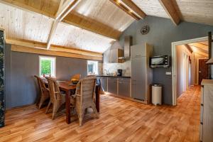 a kitchen and dining room with a table and chairs at Boshuis in Appelscha