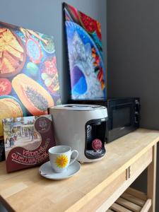 a coffee maker on a counter next to a microwave at Karlovy Vary Cute in Karlovy Vary +5 photos