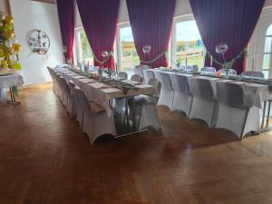 a row of tables and chairs in a room at Landhotel Kreien in Kreien