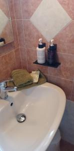 a bathroom with a sink and two bottles of soap at Vilana Studios in Kálamos Kythira