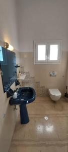 a bathroom with a black sink and a toilet at La maison des oliviers in Kiáton +22 photos