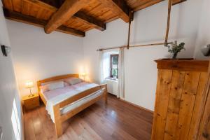 a bedroom with a bed in a room with wooden floors at Mlýn Davídkov in Hryzely +32 photos