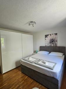 a bedroom with a large bed with white sheets at Apartment MARO in Senj