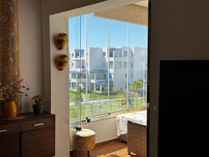 a room with a large window with a view of a building at Mirador Capo Negro in Cabo Negro