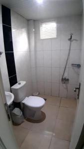 a bathroom with a toilet and a shower in it at Volkii Otel1 in Antalya