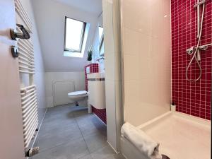 a bathroom with a shower and a toilet and a sink at Helbings Apartments Essen in Essen