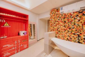 a bathroom with a large wall of flowers at YUSU Hotel in Kata Beach