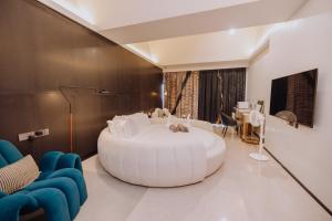 a bathroom with a large white tub in a room at YUSU Hotel in Kata Beach