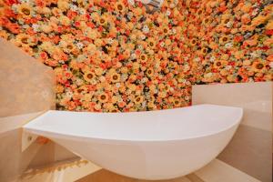 a wall covered in flowers with a white wall at YUSU Hotel in Kata Beach