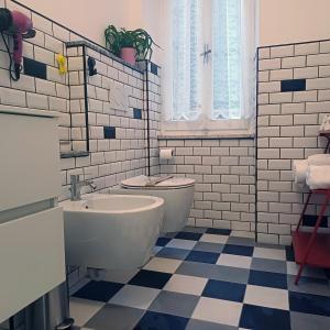 a white bathroom with a toilet and a sink at Appartamento Diana in Orvieto