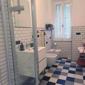 a bathroom with a toilet and a sink and a mirror at Appartamento Diana in Orvieto +2 photos