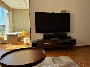 a living room with a flat screen tv on the wall at Mirador Capo Negro in Cabo Negro