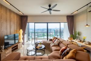 a living room with a large couch and a television at Lakeville Residence by Feel Home in Kuala Lumpur