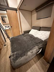 a bedroom with a bed in a small room at Luxury Lakeside Retreat - The Cozy Wondrous Weekendator in Lake Ariel