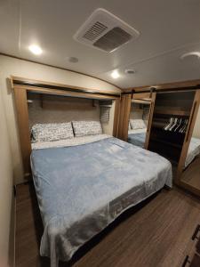 a bed in the middle of a room at Luxury Lakeside Retreat - The Cozy Wondrous Weekendator in Lake Ariel