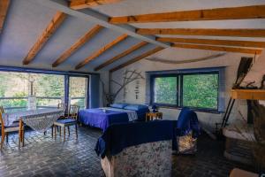 a room with a bed and a table and chairs at ECO Beach Houses - Pet friendly in Peroj