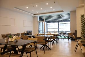 a dining room with tables and chairs and windows at Home Plus Hotel in Istanbul