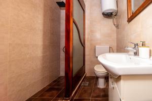 a bathroom with a sink and a toilet at Apartments Kole in Rafailovici