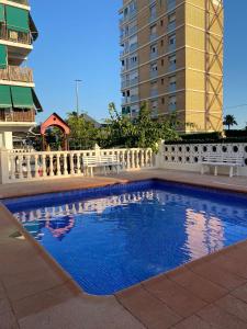 a swimming pool in a city with a building at Brisa Marina in Las Canteras