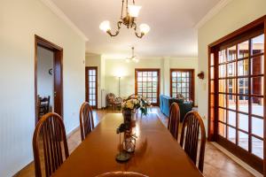 a dining room with a wooden table and chairs at Artemida Beachside Villa Escape - 50m by the Sea in Artemida