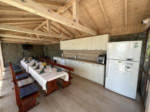 a kitchen with a table and a white refrigerator at Villa Azur- Sea View Luxury with Pool near Balchik in Albena