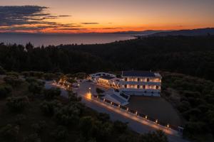 an aerial view of a building with lights at sunset at Amara Suites in Neos Marmaras