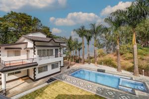 an aerial view of a house with a swimming pool at Aqua Villa, Esperanza by Svar Stays with Breakfast, Swimming Pool view & Valley View in Panchgani