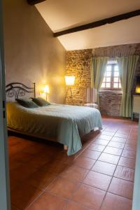 a bedroom with a bed and a window at La Vieille Demeure in Torreilles
