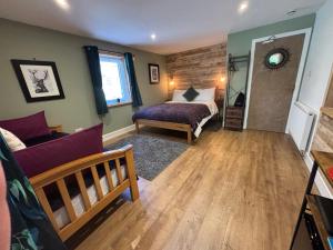 a bedroom with a bed and a couch at Ardenbeg in Grantown on Spey