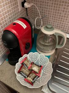 a red toaster sitting on a counter next to a tea kettle at Casa Valente in Manfredonia +8 photos