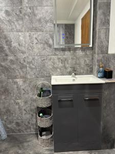 a bathroom with a sink and a counter with baskets at Ardenbeg in Grantown on Spey +26 photos